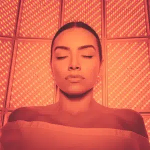 Woman In LightStim Red Light Therapy Bed